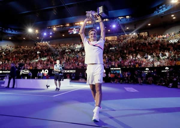STAR MAN: Switzerland's Roger Federer holds his trophy up after defeating Croatia's Marin Cilic in the men's singles final at the Australian Open. Picture: AP/Vincent Thian