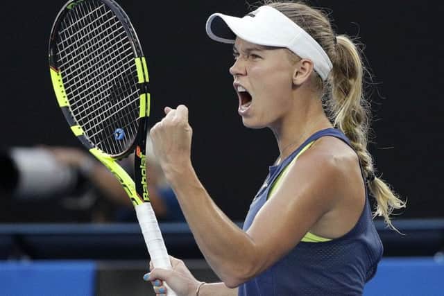 Denmark's Caroline Wozniacki celebrates winning a point while playing Simona Halep on Saturday. Picture: AP/Dita Alangkara