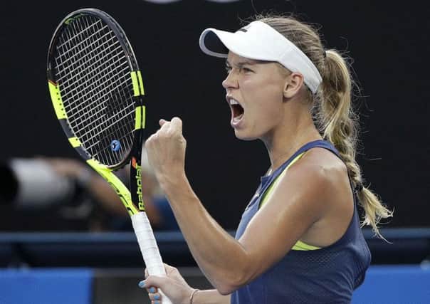 Denmark's Caroline Wozniacki celebrates winning a point while playing Simona Halep on Saturday.  Picture: AP/Dita Alangkara