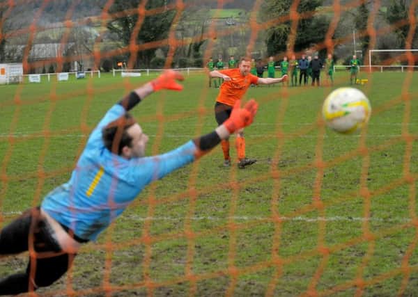 Jonathon Unwin scores the fifth and final penalty for Otley Town in their West Yorkshire League, League Cup second-round win over Hunslet Club. PIC: Steve Riding