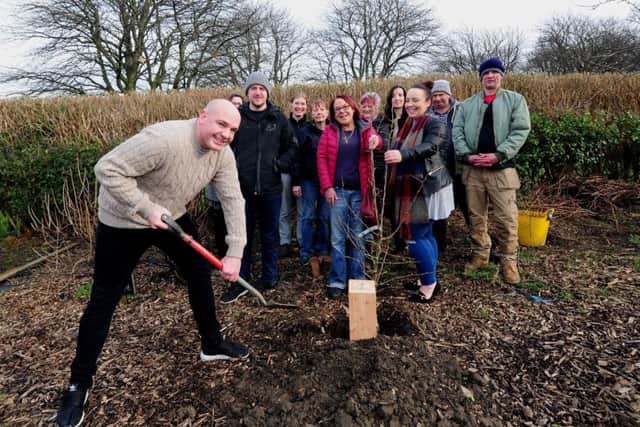 Tree planting in memory of Kevin Collinson. Kevin's son Kieran Collinson is pictured with the spade.