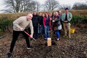 Tree planting in memory of Kevin Collinson. Kevin's son Kieran Collinson is pictured with the spade.