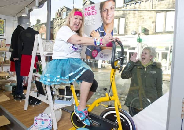 Jeanette Boyle spent the day on an exercise bike in the window of Cancer Research UKs charity shop in Horsforth to launch a week of fun fundraising activities in the lead up to World Cancer Day on Sunday 4 February. Picture: Richard Walker / www.imagenorth.net