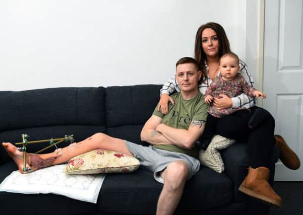 Hit and run victim Stuart Sunderland with partner Jessica O'Connell and their seven-month-old daughter, Reenie. Pic: Jonathan Gawthorpe