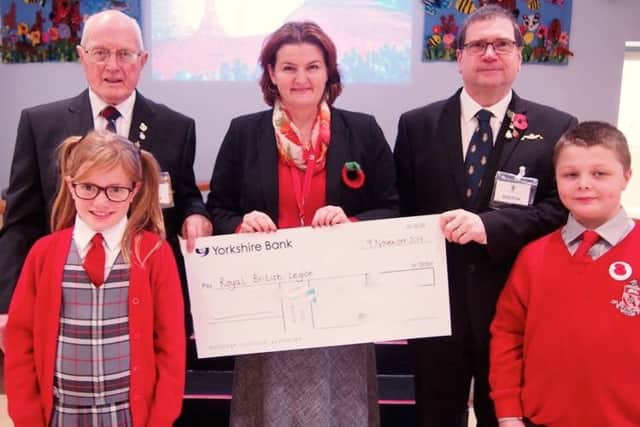 The school hands over a cheque to the Royal British Legion