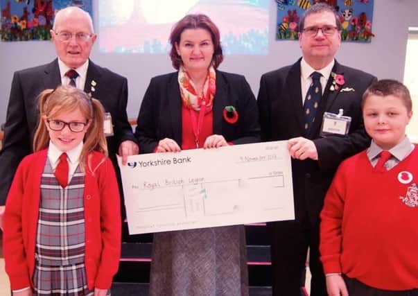 The school hands over a cheque to the Royal British Legion