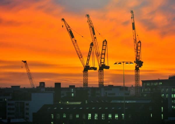 Cranes silhouetted against a spectacular sunrise in the centre of Leeds.
 Picture Gerard Binks