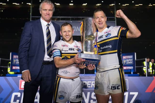 Leeds' Danny McGuire, Rob Burrow and head coach Brian McDermott celebrate with the Super League Grand Final trophy at Old Trafford last year. Picture by Alex Whitehead/SWpix.com