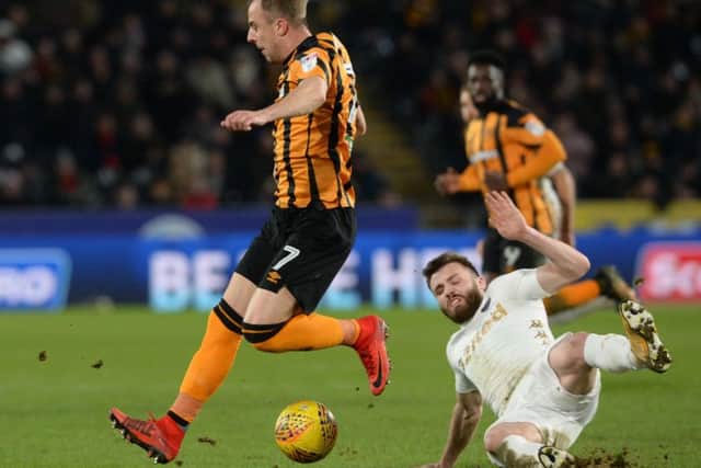 Kamil Grosiicki avoids a challenge from Stuart Dallas.