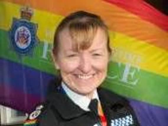 Chief Constable Dee Collins raises one of the rainbow flags being flown outside West Yorkshire Police stations this month.