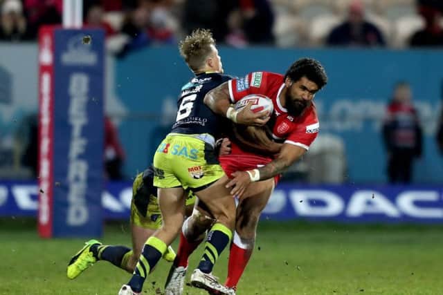 Hull KR's Mose Masoe (right) is tackled by Jacob Miller