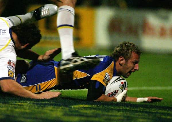 Leeds' Rob Burrow (right) scores the first try during the Engage Super Leauge play-off against Warrington at Headingley Stadium. PIC: Nigel Roddis/PA