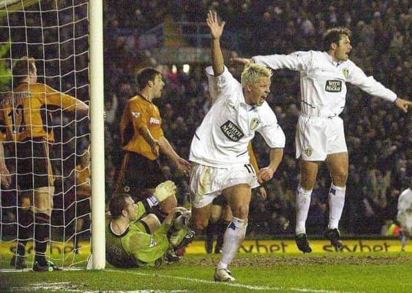 Leeds United's Alan Smith (centre) celebrates scoring the opening goal against Wolves in February 2004. Right, last-minute scorer Mark Viduka. PIC: Gareth Copley