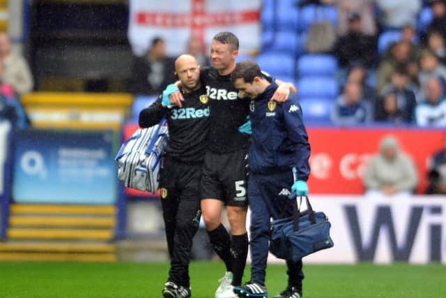 Matthew Pennington limps out of Leeds' victory at Bolton Wanderers on the first day of the season.