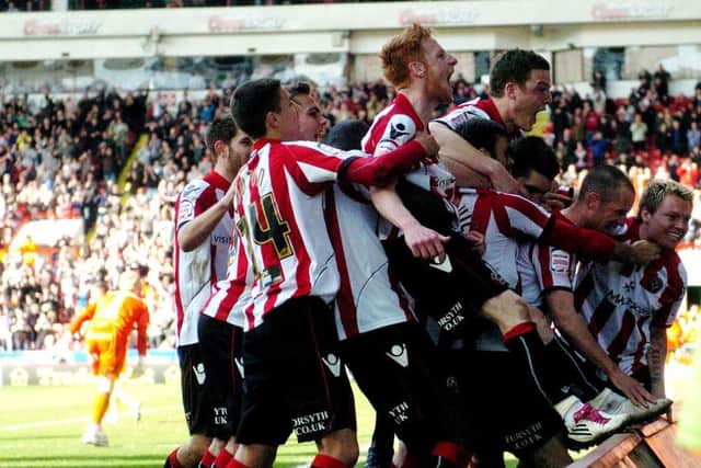 Sheffield United players mob scorer of the second goal Bjorn Helge Riise (far right) in March 2011. Picture: Jonathan Gawthorpe