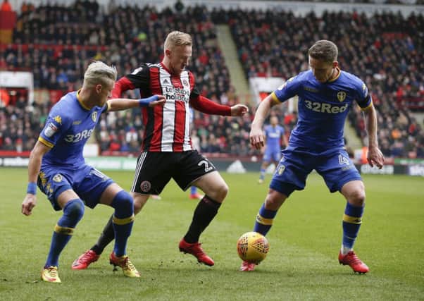 Ezgjan Alioski and Adam Forshaw of Leeds United tackle Mark Duffy. PIC: Simon Bellis/Sportimage