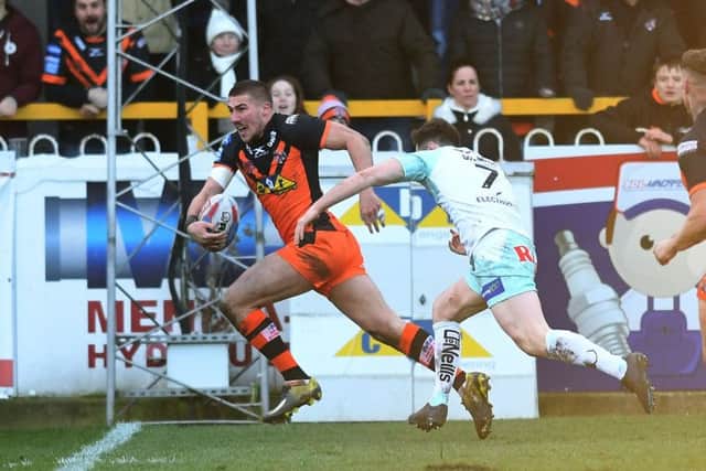 Castleford's Greg Minikin gets away from Widnes' Thomas Gilmore to score the opening try. PIC: Jonathan Gawthorpe