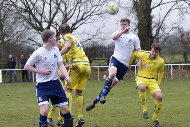 Charlie Lumley rises high for Leeds City against Pool. PIC: Steve Riding