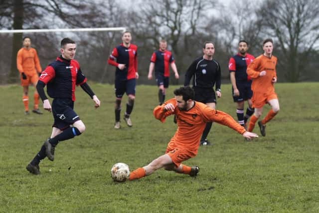 Chris Moore slides in for Shire III ahead of Old Batelians Reserves' James Byrne. PIC: Steve Riding