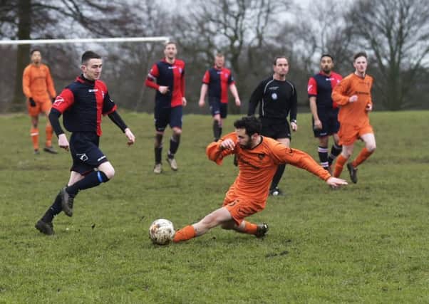 Chris Moore slides in for Shire III ahead of Old Batelians Reserves' James Byrne. PIC: Steve Riding