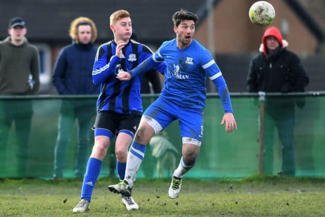 Harry Pickup, of Kippax, challenges HT Sports' Sam Ackroyd. PIC: Jonathan Gawthorpe