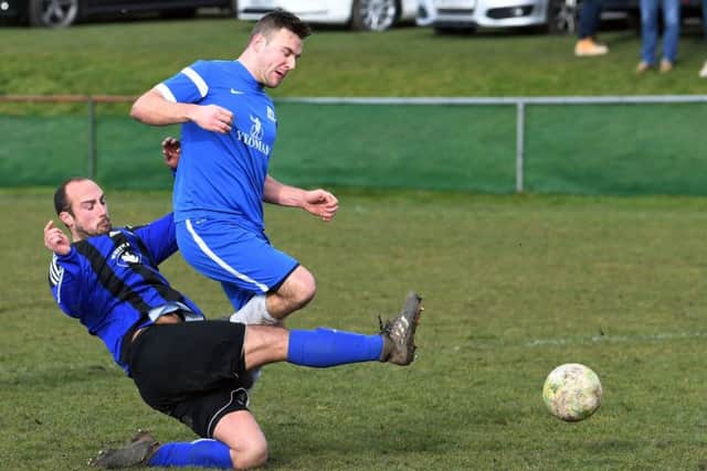 Kippax's Liam Walton tackles Ben Thornton, of HT Sports, during Sunday's Sanford Cup encounter. PIC: Jonathan Gawthorpe