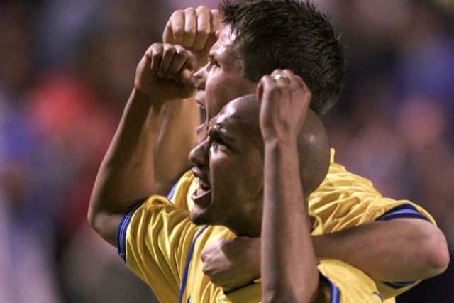 Olivier Dacourt (front) and Eirik Bakke celebrate Leeds United reaching the semi-finals of the Champions League.