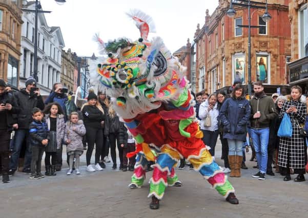 HAPPY NEW YEAR: Leeds shoppers enjoy the traditional lion dance. PIC: Tony Johnson