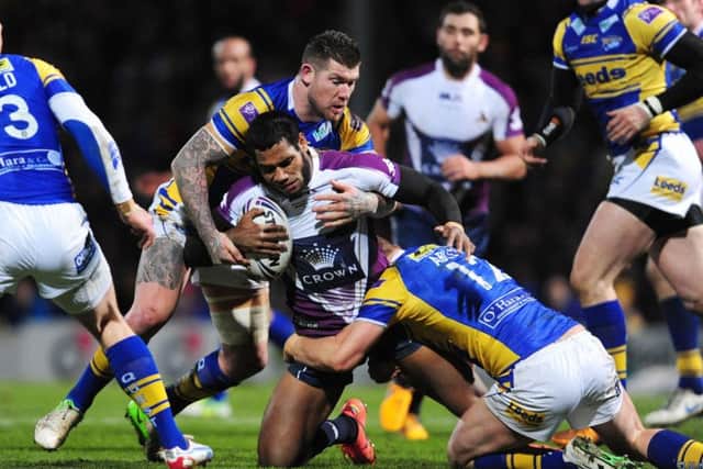 Melbourne Storm's Sisa Waqa is tackled by Leeds Rhinos' Brett Delaney (left) and Carl Ablett during the World Club Challenge in 2013.