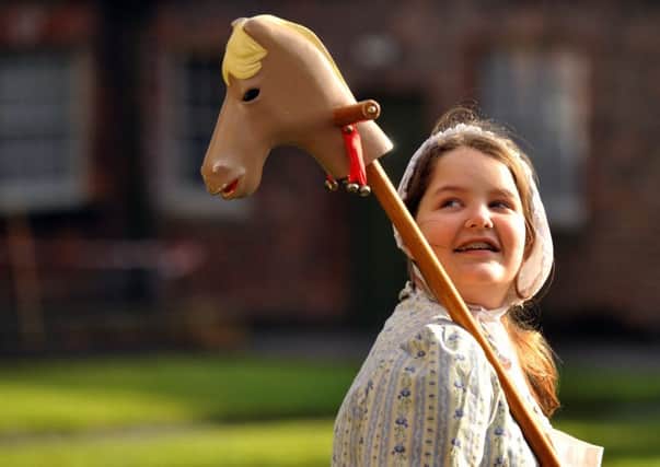 Young curator Tia Thorpe with a hobby horse. PIC: Gary Lomgbottom