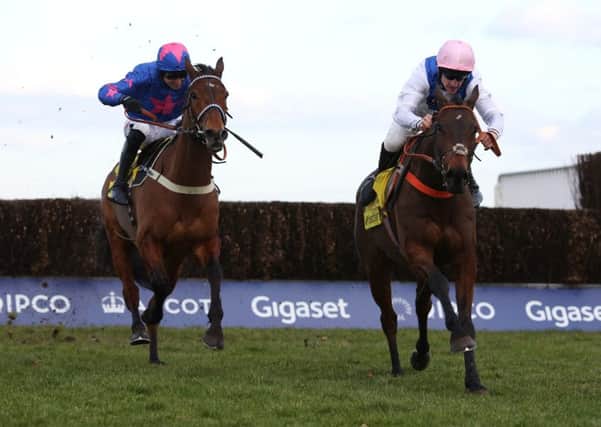 Waiting Patiently and Brian Hughes (right) lead Cue Card and Paddy Brennan away from the last fence before going on to win The Betfair Ascot Steeple Chase Race run during The Betfair Ascot Chase Raceday at Ascot.