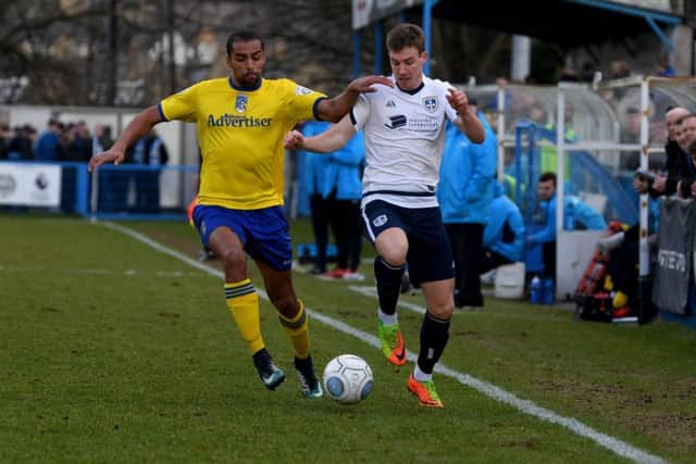 Remy Clerima, of Maidenhead United, tackles Dayle Southwell. PIC: James Hardisty