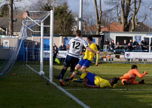 Dayle Southwell, of Guiseley, scores against Maidenhead United, at Nethermoor. PIC: James Hardisty