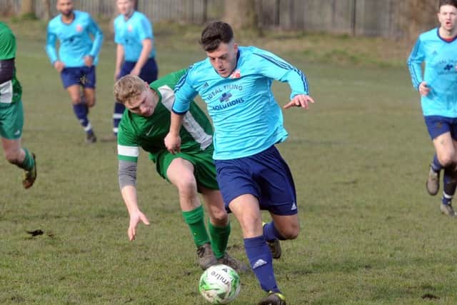 Leodis' Connor Lomas bursts away from  Rick Simpson, of New Pudsey. PIC: Tony Johnson