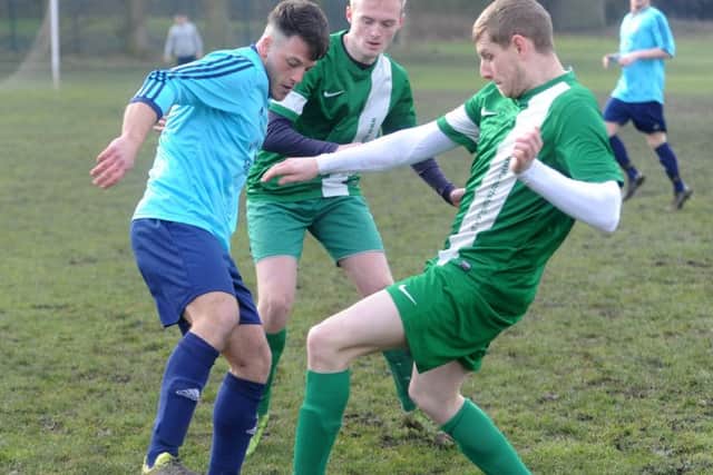 New Pudsey's Dave Thornton, right, and Brandon Baldwin double up on Connor Lomas, of Leodis. PIC: Tony Johnson
