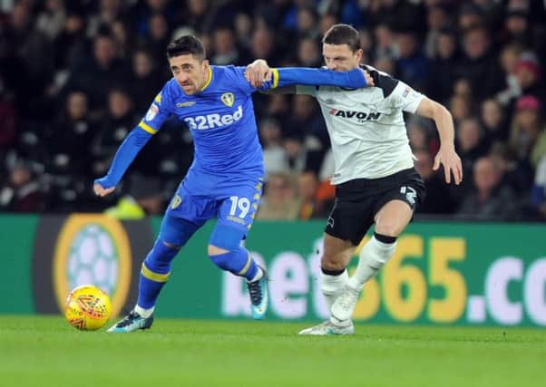 DOUBTFUL: Leeds United's Pablo Hernandez, left, pictured tussling with Derby County's Chris Baird before picking up a groin injury. Picture by Tony Johnson.