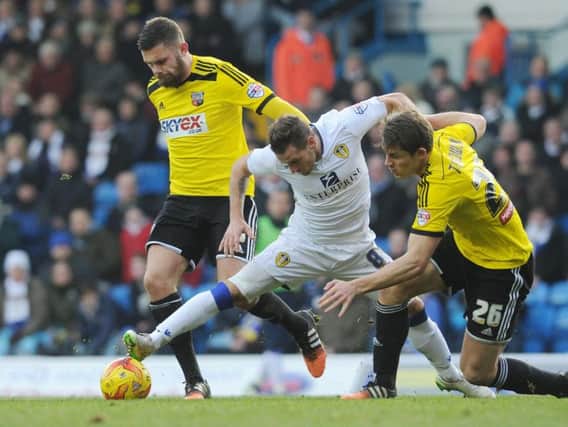 TOUGH BATTLE: Leeds' Billy Sharp finds himself under pressure from Brentford's Harlee Dean and James Tarkowski during the Championship encounter at Elland Road back in February 2015. The Bees won 1-0.