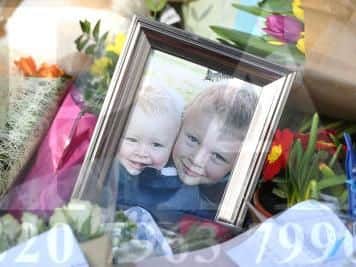Flowers close to the scene where brothers Corey Platt-May and Casper, aged six and two, were killed in a hit-and-run collision in Coventry after being struck by a car on Thursday afternoon.