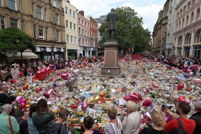 Flowers and tributes left in St Ann's Square in Manchester following the Manchester Arena terror attack. Credit: Danny Lawson/PA Wire.