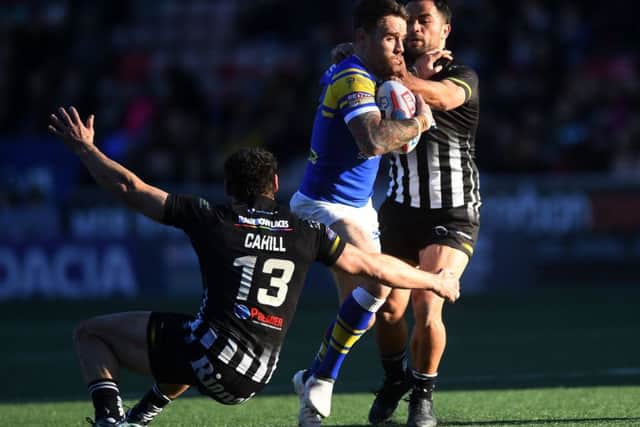 Richie Myler is tackled by Hep Cahill and Aaron Heremaia.