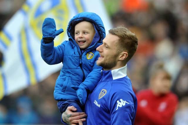 20 January 2018...... Leeds United v Millwall
Leeds captain Liam Cooperb brings young Toby Nye onto the pitch. Picture Tony Johnson.