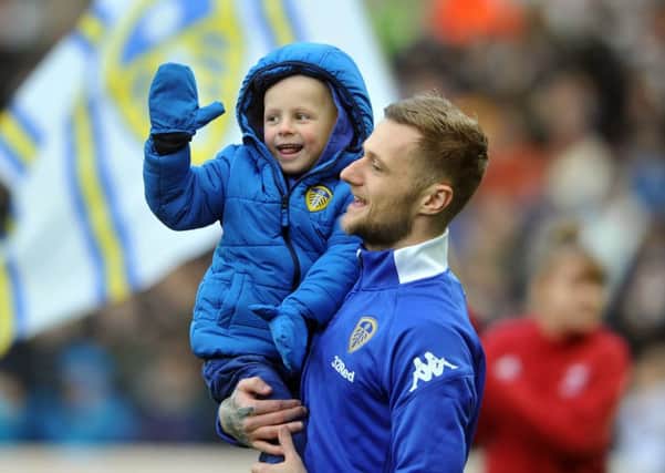 20 January 2018......    Leeds United v Millwall
Leeds captain Liam Cooperb brings young Toby Nye onto the pitch. Picture Tony Johnson.