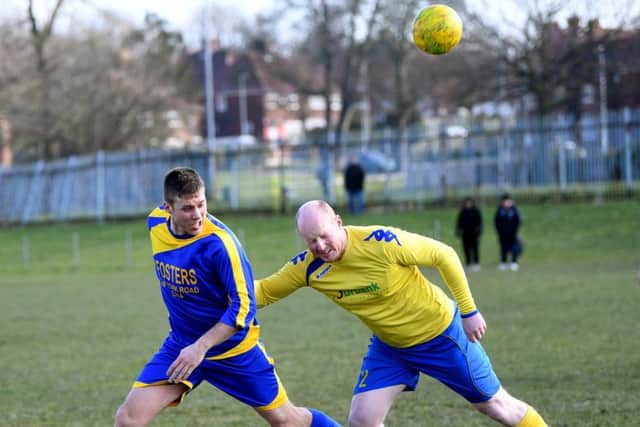 Seacroft's Joe Johnson wins a header from Halfway House's Luke Backhouse. PIC: Jonathan Gawthorpe