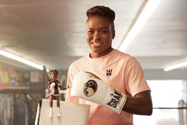 Leeds's double Olympic boxing champion Nicola Adams with a one-off first ever "boxer Barbie", which was  unveiled for International Women's Day. PHOTO: Mattel/PA Wire