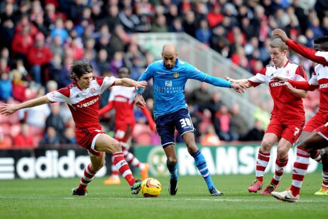 Leeds United's Jimmy Kebe battles with Middlesbrough's George Friend in February 2014.