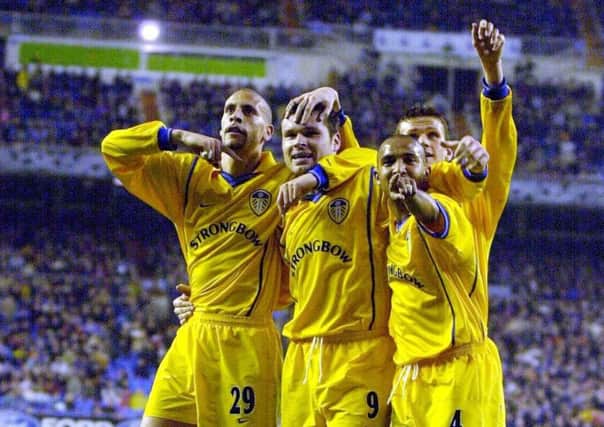 Leeds United's players celebrate Mark Viduka's goal.