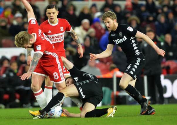 TUSSLE: Leeds United's Stuart Dallas, centre, and Eunan O'Kane, right, try to hunt down Middlesbrough's former Whites player Adam Clayton. Picture by Bruce Rollinson.