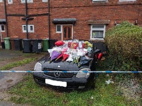 Floral tributes at the scene of the fatal house fire