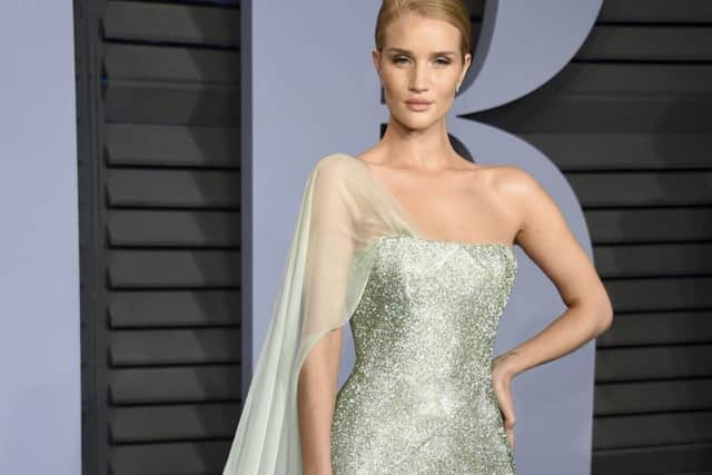 CELEB GET THE BEAUTY LOOK: Rosie Huntington-Whiteley arrives at the Vanity Fair Oscar Party looking serenely regal. The make-up is low-key and glow-y, blendy golden tawny shades and finished with a full nude semi-matte lip. Try MAC Matte Lipstick in Velvet Teddy, Â£17.50. (Photo by Evan Agostini/Invision/AP)