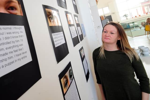 Young persons outreach worker Carwen Jones, of Basis Yorkshire, looks over the In Our Own Words exhibition. Pictures: Simon Hulme